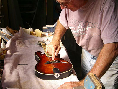 Allan Tomkins puts the finishing touches to Don Raby's mandolin