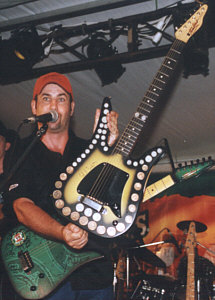 Col Finley with his own Tomkins guitar, inlaid with coins