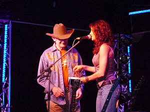 Shea Fisher presents a custon belt buckle to Allan Tomkins